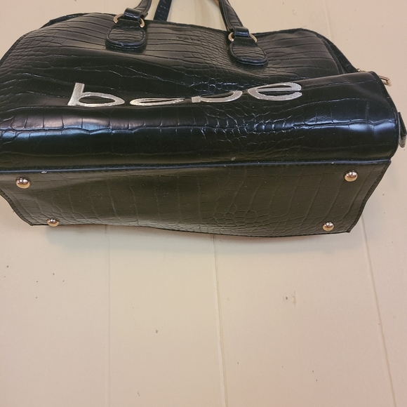 Bebe, Black Handbag. Handbag studs on bottom. Gold lettering. - Picture 2 of 4